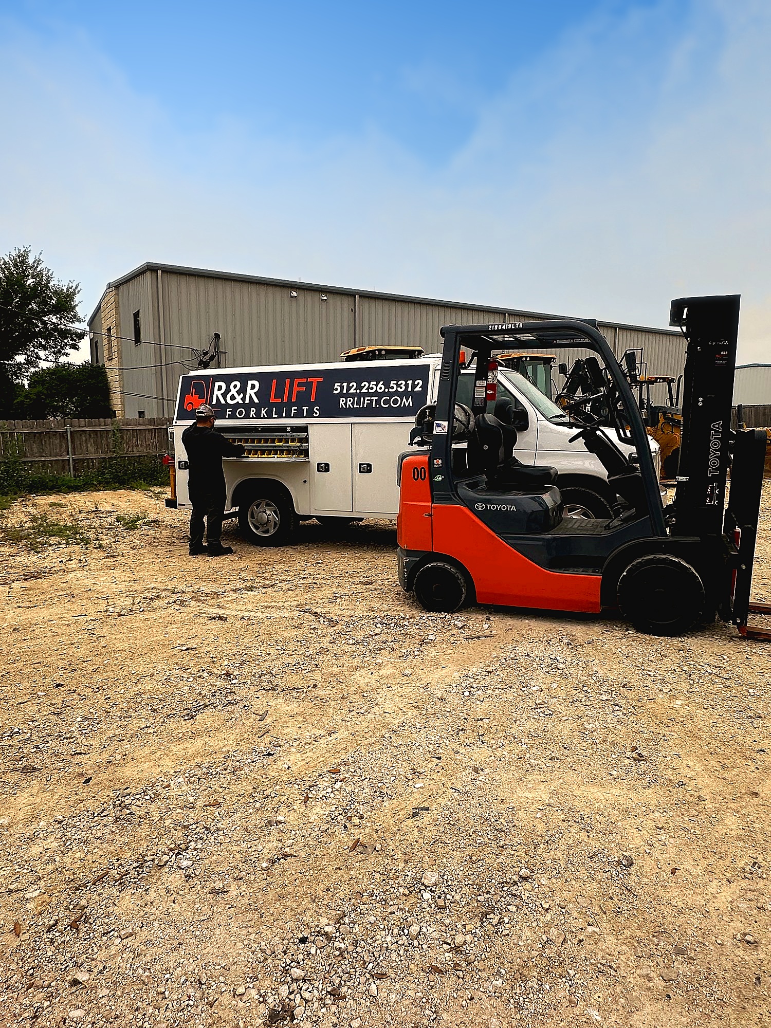 Fleet manager reviewing forklift maintenance records while evaluating service provider performance in a warehouse