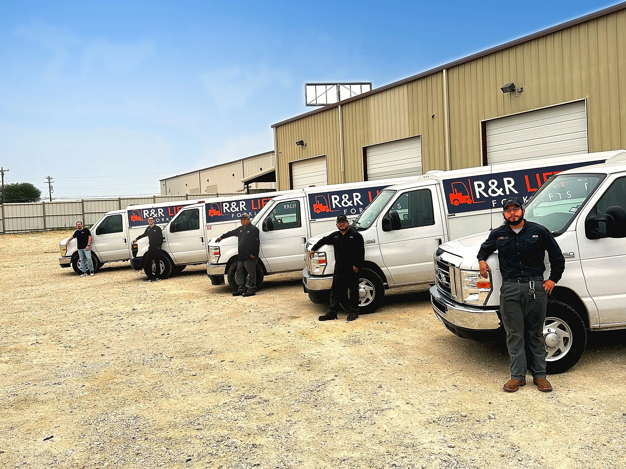 R&R Lift team standing with the service truck fleet